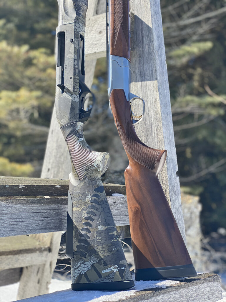 Two shotguns leaning against a rest.