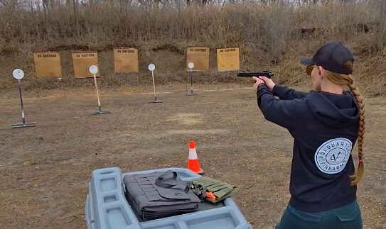 Jenna Larsen shooting at steel targets with a rimfire pistol.