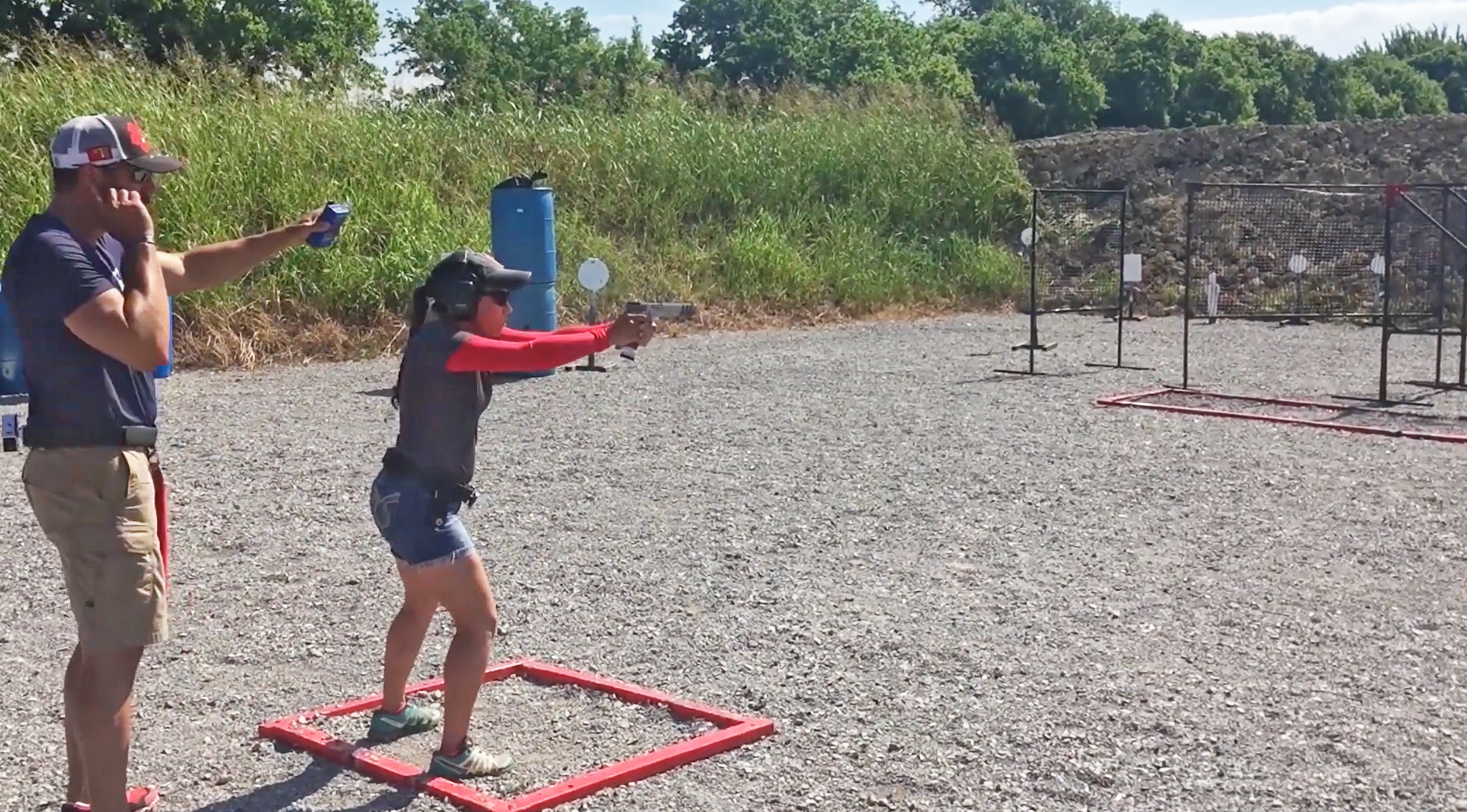 Gabby Franco engaging targets during a match at an outdoor range.