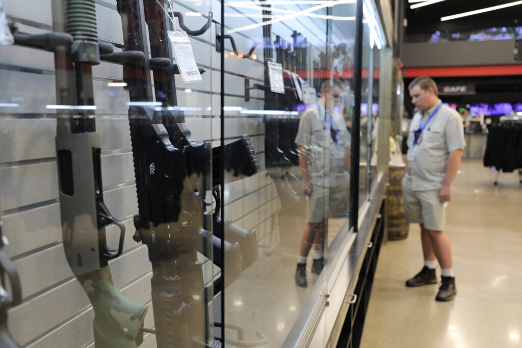 Man looking at shotgun display case while at Lake Erie Arms.