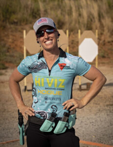 Lanny Barnes showcasing her preferred holster setup with extra magazines.